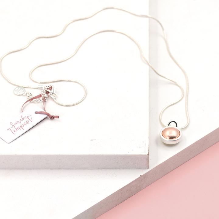 ORB SHAPED PENDANT WITH ROSE GOLD INLAY ON LONG NECKLACE