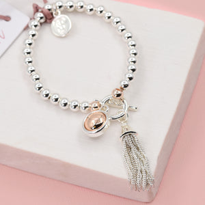 ROSE GOLD BEADED BRACELET WITH ORB AND TASSEL CHARMS AND T BAR CLASP